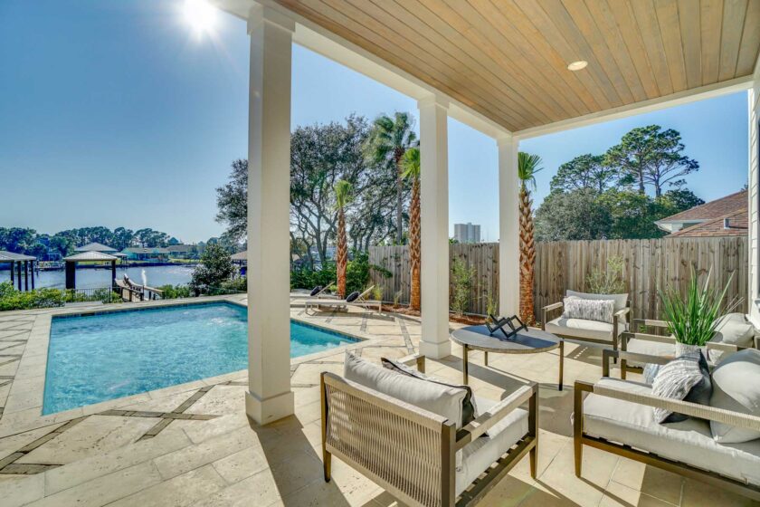 view of pool and water from deck seating