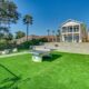 green grass and ping pong and seating area out back