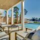 Deck in back yard with pool and water view