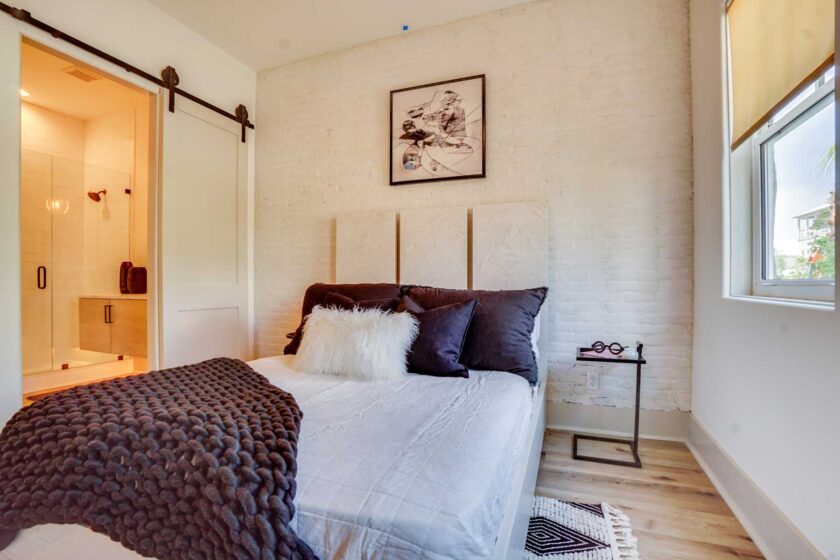 bedroom with brick accent wall